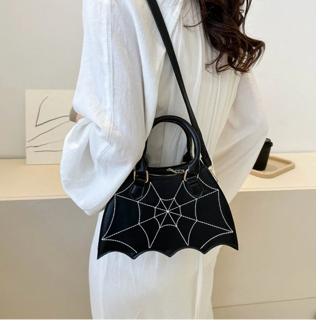 Black spiderweb Halloween handbag worn crossbody